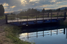 A bridge over the pond on a sunny day at Soda Creek Campground in Soda Springs, Idaho.
