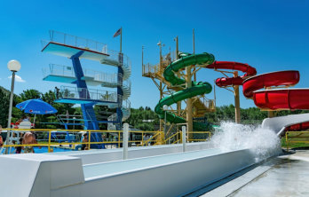 A teenager sliding down one of the red, blue, and green waterslides at Lava Hot Springs near Soda Creek Campground in Soda Springs, Idaho.
